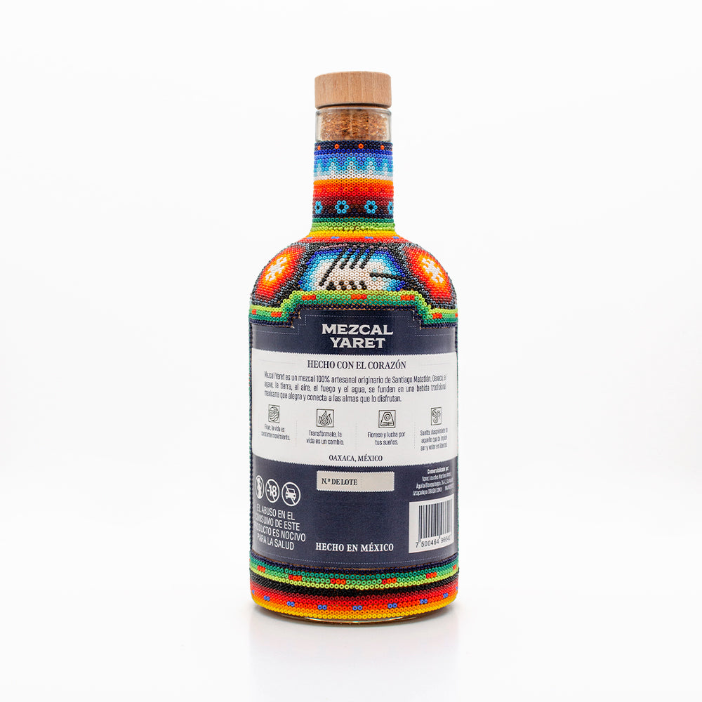 Botella con arte Huichol Mezcal Espadín Abocado con gusano de magüey 750 ML
